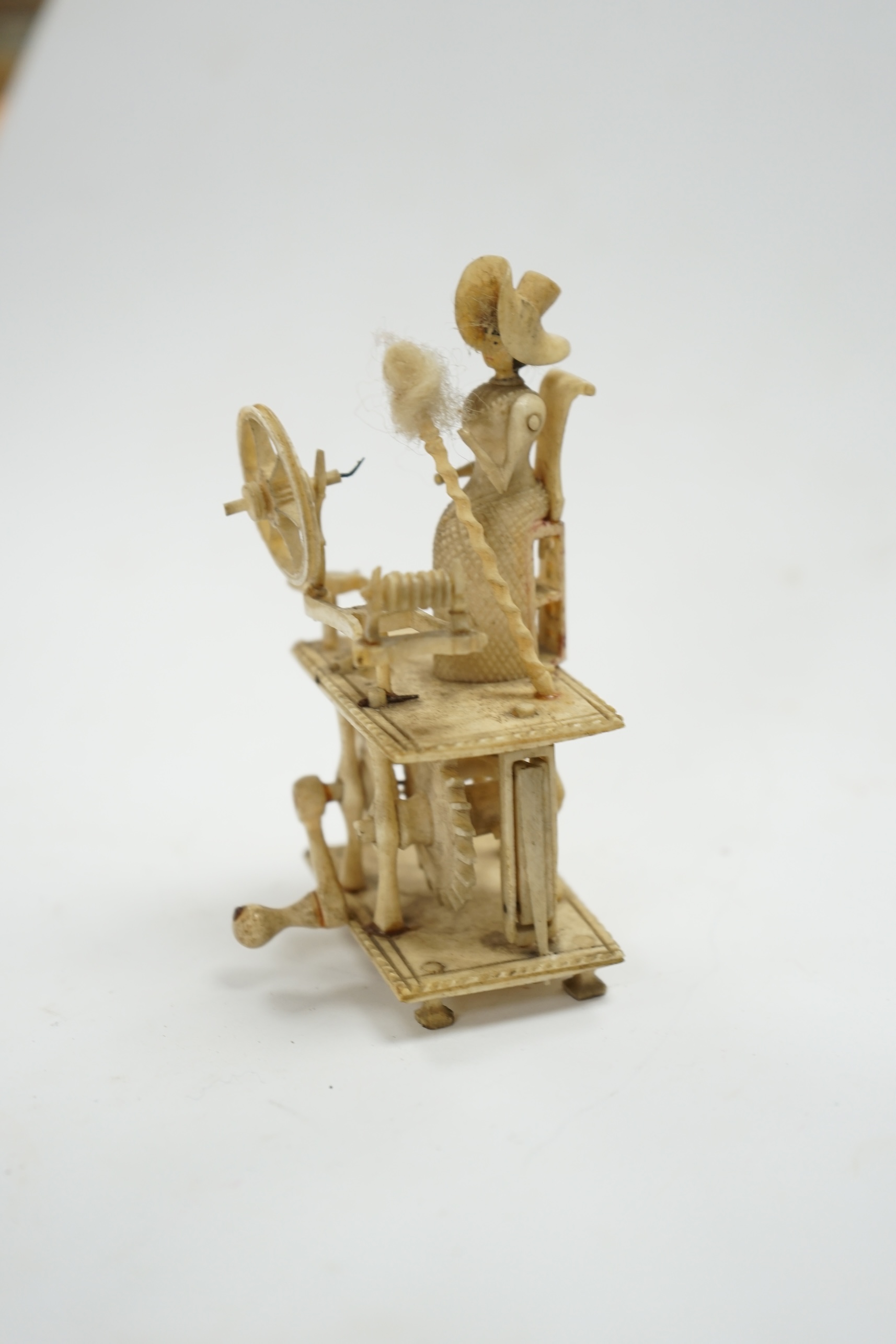 A Napoleonic Prisoner of War-work carved bone miniature ‘Spinning Jenny’, 10.5cm high. Condition - fair to good considering age